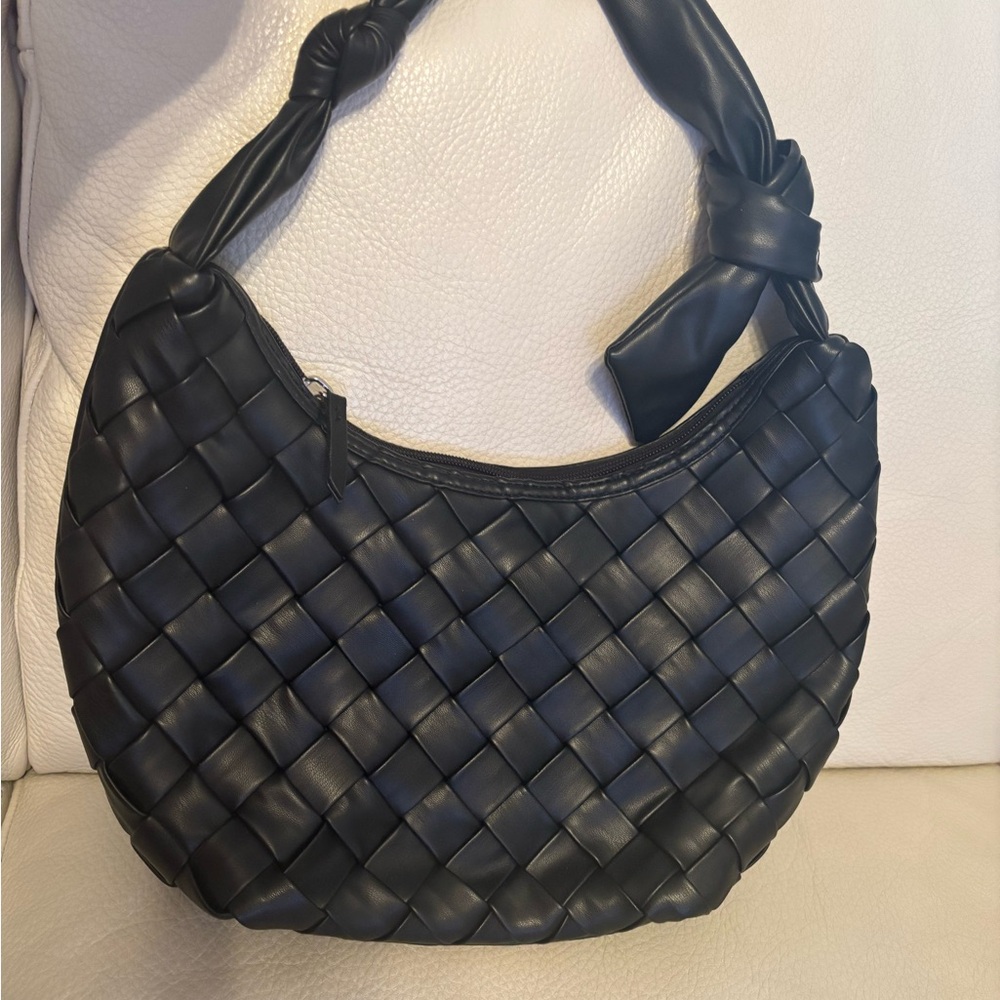 Really pretty soft basket weave bag. Not leather